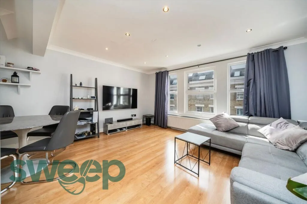 A clean living room with a grey sofa
